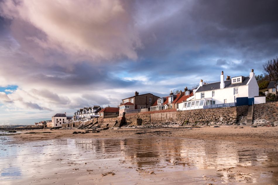 View of houses along Lower Largo shore, with dramatic sky in the background