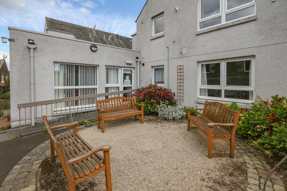 Image of outdoor seating area, with benches, in Burgh House